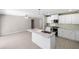 An open kitchen with marble countertops, stainless steel appliances, and an island with sink and seating at 5992 Osprey Rd, Venice, FL 34293
