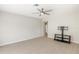 Bright living room featuring a ceiling fan, mounted TV, and wood-look floors at 5992 Osprey Rd, Venice, FL 34293