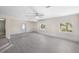 Bright and open living room featuring light wood-look flooring and a ceiling fan at 5992 Osprey Rd, Venice, FL 34293