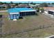 Backyard showcasing a screened lanai, a shed, and a fenced-in lawn at 6422 Otis Rd, North Port, FL 34287