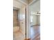 Bathroom with tiled shower is attached to bedroom with ceiling fan and wood-look floors at 6422 Otis Rd, North Port, FL 34287