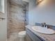 Bathroom with granite counter, toilet, and tiled shower with glass doors at 6422 Otis Rd, North Port, FL 34287