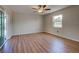 Empty bedroom featuring wood-look floors, ceiling fan and sliding doors to lanai at 6422 Otis Rd, North Port, FL 34287