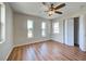 Bedroom features wood-look floors, ceiling fan, and closet at 6422 Otis Rd, North Port, FL 34287