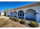 Close-up of 6422 showcasing arched entryway, tiled porch, and lush landscaping at 6422 Otis Rd, North Port, FL 34287