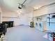 Spacious two car garage with painted floor, shelving, washer, and dryer at 6422 Otis Rd, North Port, FL 34287