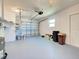 Spacious two car garage with painted floor, shelving, and overhead door opener at 6422 Otis Rd, North Port, FL 34287