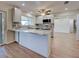 Bright kitchen with stainless steel appliances, light gray cabinetry, and granite countertops at 6422 Otis Rd, North Port, FL 34287