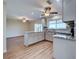 Modern kitchen with stone countertops, stainless steel appliances, and open view to living room at 6422 Otis Rd, North Port, FL 34287