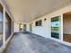 Spacious covered outdoor patio with access to backyard, bright lighting, and modern design at 6422 Otis Rd, North Port, FL 34287