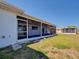 Screened patio with stone steps leading to the backyard with a neighboring property with fence at 6422 Otis Rd, North Port, FL 34287