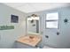 Well lit bathroom with light walls, decorative art, and a single sink vanity at 6451 Keena Ct, North Port, FL 34287