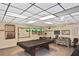 The community billiards room is equipped with a pool table, cues, and comfortable seating at 6451 Keena Ct, North Port, FL 34287