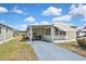 Well-maintained home featuring a covered carport, attractive landscaping, and a cozy front porch at 6451 Keena Ct, North Port, FL 34287