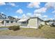 Charming home with awnings and manicured lawn offering a comfortable and inviting curb appeal at 6451 Keena Ct, North Port, FL 34287