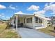 Cozy home featuring a covered carport, an inviting front entrance, and well-kept landscaping at 6451 Keena Ct, North Port, FL 34287
