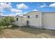 Property exterior with shed and well-maintained lawn under a beautiful blue sky with puffy white clouds at 6451 Keena Ct, North Port, FL 34287