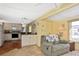 Modern kitchen area with white cabinetry, wood floors, and a cozy breakfast bar at 6451 Keena Ct, North Port, FL 34287