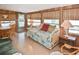 Cozy living space featuring wood paneling, a daybed, and dining set for a warm and inviting atmosphere at 6451 Keena Ct, North Port, FL 34287