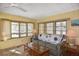 Cozy living area featuring many windows with natural light and a comfortable sofa at 6451 Keena Ct, North Port, FL 34287