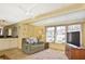Comfortable living area with adjacent kitchen and a ceiling fan at 6451 Keena Ct, North Port, FL 34287