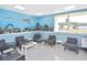 Inviting lounge area with comfortable seating, bright light, and an ocean-themed mural at 6451 Keena Ct, North Port, FL 34287