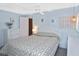 Cozy main bedroom with blue walls, a floral bedspread, and a bright window at 6451 Keena Ct, North Port, FL 34287