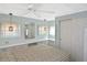 Calming main bedroom with cool blue walls, double closets, and light filtering window treatments at 6451 Keena Ct, North Port, FL 34287