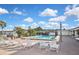 Inviting pool with surrounding lounge chairs and lush palm trees, perfect for relaxation and recreation at 6451 Keena Ct, North Port, FL 34287