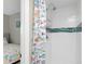 Bathroom with a modern shower and fun, colorful shower curtain at 649 Tamiami S Trl # 106, Venice, FL 34285