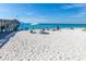 Picturesque beach scene with a pier, white sand, and people enjoying the sun at 649 Tamiami S Trl # 106, Venice, FL 34285