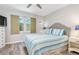 This bedroom features a comfortable bed, a window, and side tables with lamps at 649 Tamiami S Trl # 106, Venice, FL 34285