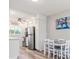 Charming dining area with hardwood floors, modern decor, and a view into the kitchen at 649 Tamiami S Trl # 106, Venice, FL 34285