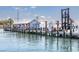 A marina fuel dock on the water with a building and boat lift at 649 Tamiami S Trl # 106, Venice, FL 34285