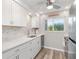 Stylish kitchen with white cabinets, stainless appliances, and sleek countertops at 649 Tamiami S Trl # 106, Venice, FL 34285