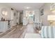 Spacious living room with modern decor, hardwood floors, and an open view to the kitchen and dining area at 649 Tamiami S Trl # 106, Venice, FL 34285