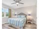 Comfortable bedroom with two side tables and a beautiful window view at 649 Tamiami S Trl # 106, Venice, FL 34285