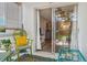 Relaxing outdoor patio offers a glimpse into the bright living room through sliding glass doors at 649 Tamiami S Trl # 106, Venice, FL 34285