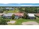 Aerial view of the house with private pool, screened in lanai and golf course behind property at 6507 Drewry'S Blf, Bradenton, FL 34203