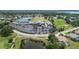Aerial view showcases a golf course, community center, pool, and lush landscaping at 6507 Drewry'S Blf, Bradenton, FL 34203