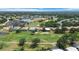 Wide aerial view of golf course community, with lake, clubhouse, and residential properties visible at 6507 Drewry'S Blf, Bradenton, FL 34203