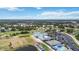 Community aerial view featuring a golf course, tennis courts, pool, and clubhouse at 6507 Drewry'S Blf, Bradenton, FL 34203