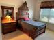 Cozy bedroom featuring antique furniture, a decorative headboard, and soft natural light at 6507 Drewry'S Blf, Bradenton, FL 34203