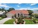 Charming single Gathering home featuring a lush landscaped yard and a classic red tile roof at 6507 Drewry'S Blf, Bradenton, FL 34203