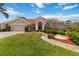 Inviting single Gathering home with lush front yard landscaping, rock features, and decorative lighting at 6507 Drewry'S Blf, Bradenton, FL 34203