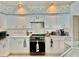Well-lit kitchen boasts white cabinets, light countertops, and modern appliances at 6507 Drewry'S Blf, Bradenton, FL 34203