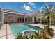 Inviting pool with a fountain and a screened enclosure and ample seating for outdoor entertainment at 6507 Drewry'S Blf, Bradenton, FL 34203