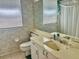 Clean bathroom with a cream vanity, tile flooring, and natural light from the window at 6507 Drewry'S Blf, Bradenton, FL 34203