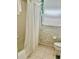 Functional bathroom with a white shower curtain, tile flooring, and standard fixtures at 6507 Drewry'S Blf, Bradenton, FL 34203