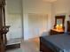 View of the bedroom showing the closet, bed, and marble top nightstand at 6507 Drewry'S Blf, Bradenton, FL 34203